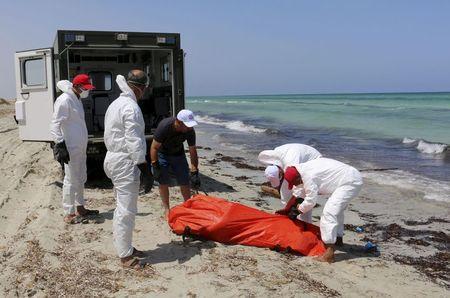 Libyan Red Crescent workers move the body of a dead migrant that was recovered by the Libyan coastguard after a boat sank off the coastal town of Zuwara, west of Tripoli, August 28, 2015. PHOTO BY REUTERS/Hani Amara