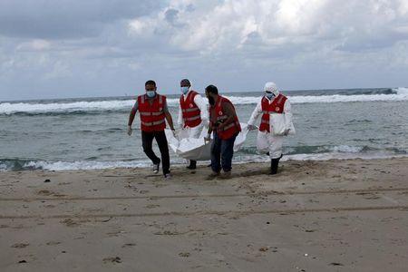 Libyan Red Crescent workers carry the body of one of the migrants who died after a boat sank off the coastal town of Khoms area east of Tripoli, Libya, October 25, 2015. PHOTO BY REUTERS/Ismail Zitouny