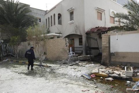 A security personnel stands near the site of a bomb blast at the gate of the Iranian ambassador's residence in Tripoli, February 22, 2015. PHOTO BY REUTERS/Ismail Zitouny