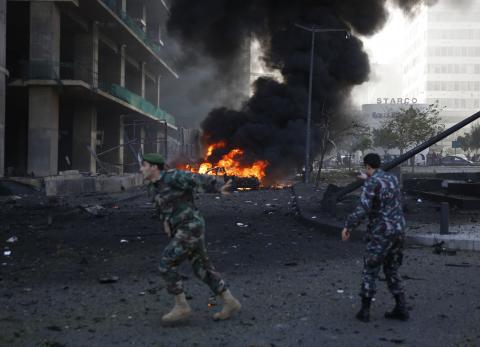 A Lebanese army soldier gestures as he runs near the site of the explosion in Beirut's downtown area