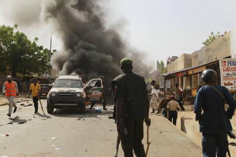 People gather to help at the scene of a bomb explosion in Gombe, February 2, 2015. PHOTO BY REUTERS/Afolabi Sotunde