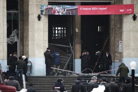 Investigators work at the site of an explosion at the entrance to a train station in Volgograd