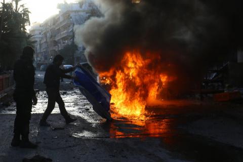 A man tries to put out a fire at a site hit by airstrikes in the rebel-controlled town of Ariha in Idlib province, Syria, February 25, 2017. PHOTO BY REUTERS/Ammar Abdullah