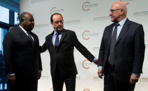 French President Francois Hollande (C) and French Finance Minister Michel Sapin (R) greet Gabon's President Ali Bongo as he arrives to attend the Franco-African Forum at the Bercy Finance Ministry in Paris, February 6, 2015. PHOTO BY REUTERS/Ian Langsdon