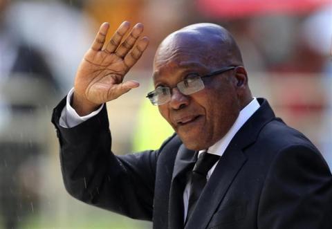 South African President Jacob Zuma waves as he arrives at the First National Bank (FNB) Stadium, also known as Soccer City, ahead of the national memorial service for late former South African President Nelson Mandela