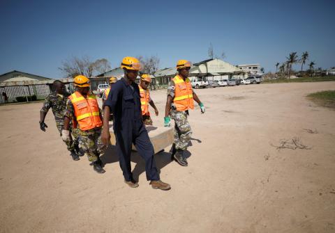 Members of Kenya's Disaster Response Unit carry boxes containing tents as they erect a temporary field hospital in Beira, Mozambique, March 26, 2019. PHOTO BY REUTERS/Mike Hutchings