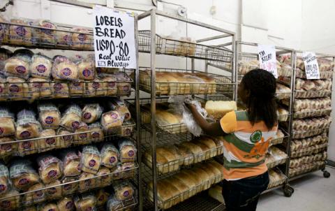 A worker arranges bread for sale inside a supermarket in Zimbabwe's capital Harare. PHOTO BY REUTERS/Philimon Bulawayo