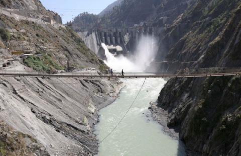 Labourers walk on a bridge near the newly inaugurated 450-megawatt hydropower project located at Baglihar Dam on the Chenab river which flows from Indian Kashmir into Pakistan, at Chanderkote, about 145 km (90 miles) north of Jammu, October 10, 2008. PHOTO BY REUTERS/Amit Gupta