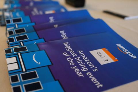 Brochures are available for potential job applicants at "Amazon Jobs Day," a job fair being held at 10 fulfillment centers across the United States aimed at filling more than 50,000 jobs, at the Amazon.com Fulfillment Center in Fall River, Massachusetts, U.S., August 2, 2017. PHORO BY REUTERS/Brian Snyder