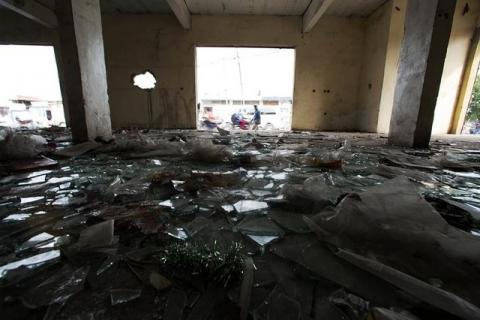 Broken glass is pictured on the floor of a looted store following violent protests in Kinshasa, Democratic Republic of Congo, January 23, 2015. PHOTO BY REUTERS/Rey Byhre