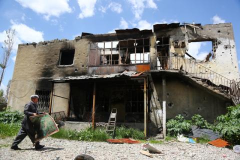 A resident returns to his building which was damaged during security operations and clashes between Turkish security forces and Kurdish militants, in Yuksekova in the southeastern Hakkari province, Turkey, May 30, 2016. PHOTO BY REUTERS/Sertac Kayar