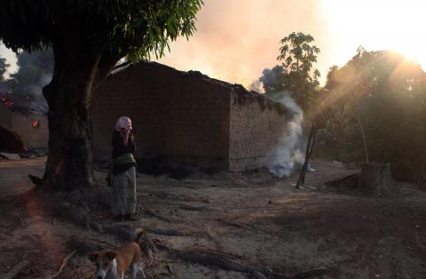 A woman looks at burning houses in Bossangoa, north of the Central African Republic's capital Bangui