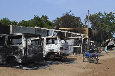 Burnt vehicles and houses are pictured on a street, after Boko Haram militants raided the town of Benisheik