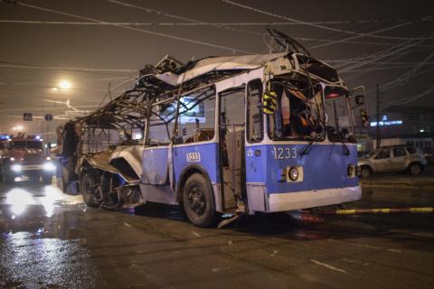 A bus, destroyed in an earlier explosion, is towed away in Volgograd