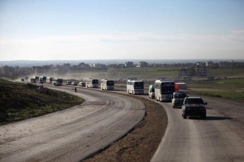 Buses carrying rebel fighters and their families who evacuated the besieged Waer district in the central Syrian city of Homs, after an agreement was reached between rebels and Syria's army, arrive on the southern outskirts of the Syrian city of al-Bab, Syria, March 19, 2017. PHOTO BY REUTERS/Khalil Ashawi