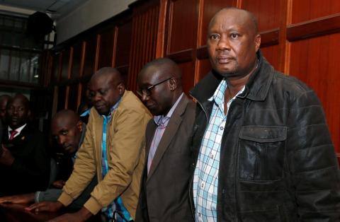 Busia county governor Sospeter Ojaamong (R) stands in the dock with his co-accused Bernard Yaite, Allan Omachari and Samuel Ombui at the Mililani Law Courts, where they were charged over the theft public funds, in Nairobi, Kenya, July 4, 2018. PHOTO BY REUTERS/Thomas Mukoya