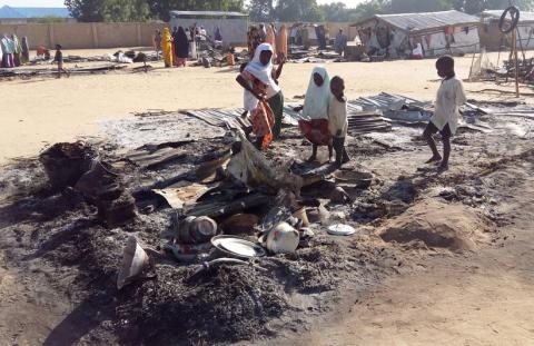 People stand amid the damage at a camp for displaced people after an attack by suspected Boko Haram insurgents in Dalori, Nigeria, November 1, 2018. PHOTO BY REUTERS/Kolawole Adewale