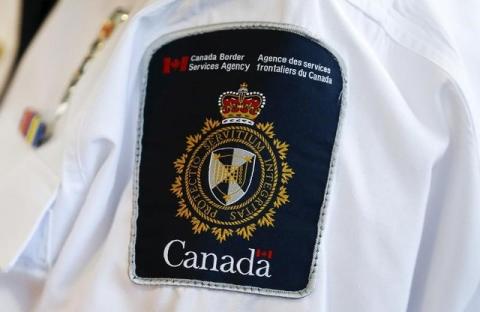 A Canada Border Services Agency (CBSA) logo is seen on a worker during a tour of the Infield Terminal at Toronto Pearson International Airport in Mississauga, December 8, 2015. PHOTO BY REUTERS/Mark Blinch