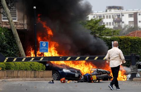 Cars are seen on fire at the scene where explosions and gunshots were heard at the Dusit hotel compound, in Nairobi, Kenya, January 15, 2019. PHOTO BY REUTERS/Thomas Mukoya