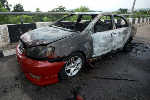 A burnt vehicle is pictured near the National Assembly building in Abuja, Nigeria, July 9, 2019. PHOTO BY REUTERS/Afolabi Sotunde