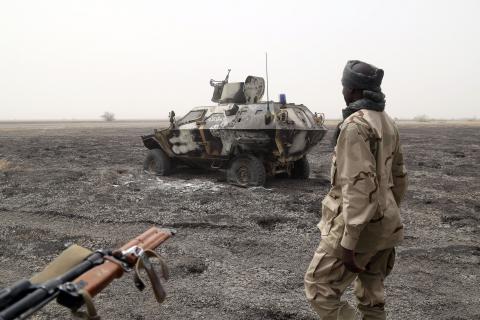 A Chadian soldier walks past an armored vehicle that the Chadian military said belonged to insurgent group Boko Haram that they destroyed in battle in Gambaru, Nigeria, February 26, 2015. PHOTO BY REUTERS/Emmanuel Braun