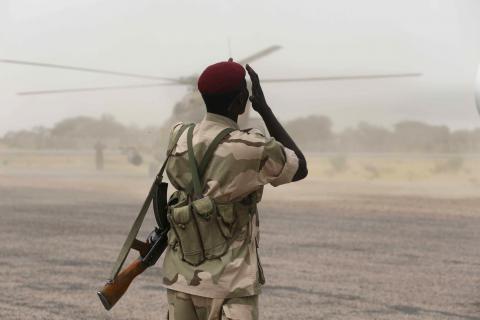 A Chadian soldier shields his face from dust kicked up by a helicopter in the recently retaken town of Damasak, Nigeria, March 18, 2015. PHOTO BY REUTERS/Emmanuel Braun