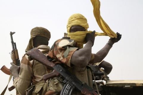 A Chadian soldier fixes his headscarf while driving at the front line during battle against insurgent group Boko Haram in Gambaru, February 26, 2015. PHOTO BY REUTERS/Emmanuel Braun