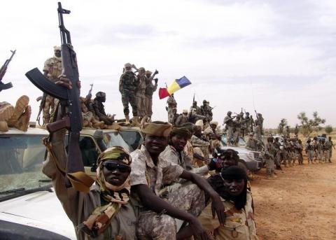 Chadian soldiers hold up their weapons next to tanks and army vehicles ahead of their deployment in Mali, at the town of Gorou, in Niger, 10 km (6.2 miles) from Niamey, January 30, 2013. PHOTO BY REUTERS/ Alain Amontchi