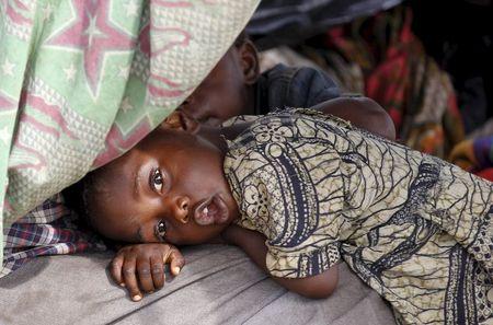 A Burundian refugee child is pictured on the shores of Lake Tanganyika in Kagunga village in Kigoma region in western Tanzania, as they wait for MV Liemba to transport them to Kigoma township, May 18, 2015. PHOTO BY REUTERS/Thomas Mukoya