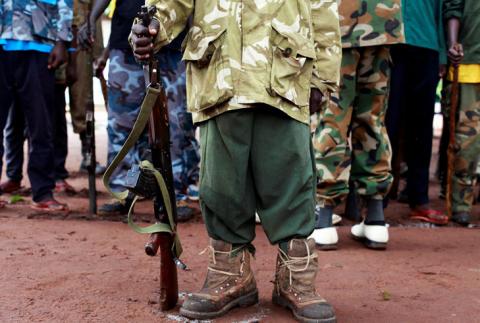 A former child soldier holds a gun as they participate in a child soldiers' release ceremony, outside Yambio, South Sudan, August 7, 2018. PHOTO BY REUTERS/Andreea Campeanu