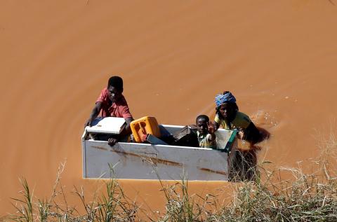 A child is transported on a fridge during floods after Cyclone Idai, in Buzi, outside Beira, Mozambique, March 21, 2019. PHOTO BY REUTERS/Siphiwe Sibeko