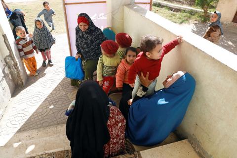 Egyptian mothers wait outside a new clinic in the province of Fayoum, southwest of Cairo, Egypt, February 19, 2019. PHOTO BY REUTERS/Hayam Adel