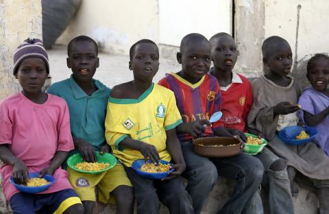 Children displaced as a result of Boko Haram attacks in the northeast region of Nigeria, sit in a row to eat a meal at a camp for internally displaced persons (IDP) in Yola, Adamawa State, January 13, 2015. PHOTO BY REUTERS/Afolabi Sotunde