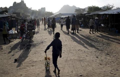 A Karamojong tribe boy plays with a toy decorated with election posters in town of Kaabong in Karamoja region, Uganda, February 17, 2016. PHOTO BY REUTERS/Goran Tomasevic