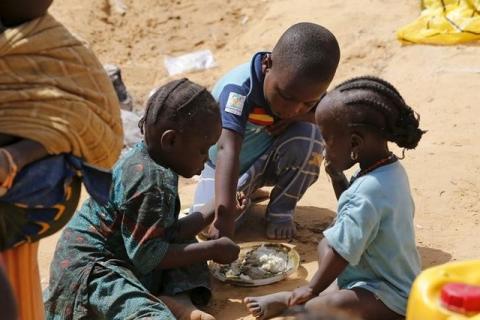 Nigerian children displaced by the Boko Haram insurgence share a meal at a registration centre in Geidam stadium, Nigeria, May 6, 2015. PHOTO BY REUTERS/Afolabi Sotunde