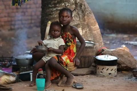 Children have their meal in a camp for internally displaced people on the grounds of the Saint Sauveur church in the capital Bangui, Central African Republic, November 25, 2015. PHOTO BY REUTERS/Siegfried Modola