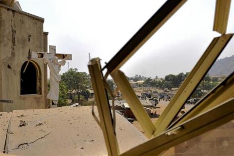 A crucifix stands near a damaged structure at the scene of a car bomb explosion at St. Theresa Catholic Church at Madalla, Suleja, just outside Nigeria's capital Abuja