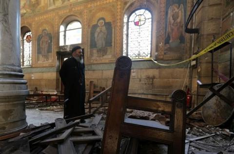 A Coptic priest stands at the scene following a bombing inside Cairo's Coptic cathedral in Egypt, December 11, 2016. PHOTO BY REUTERS/Mohamed Abd El Ghany