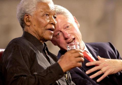 Former U.S President Bill Clinton (R) and former South African President Nelson Mandela (L) speak during a Gala night in Westminster Hall, London