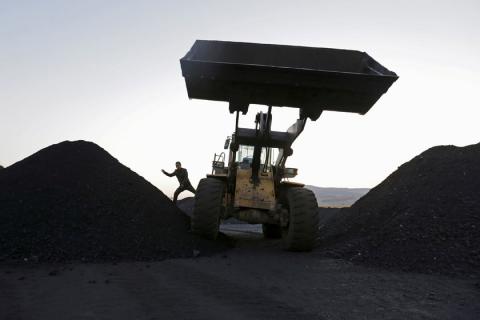 A driver gets off a loading vehicle at local businessman Sun Meng's small coal depot near a coal mine of the state-owned Longmay Group on the outskirts of Jixi, in Heilongjiang province, China, October 23, 2015. PHOTO BY REUTERS/Jason Lee