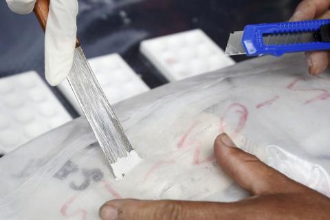 Anti-narcotics police chemists test cocaine from a bag before its incineration in Lima. PHOTO BY REUTERS/Enrique Castro-Mendivil