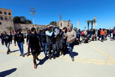 Residents carry a coffin containing a body of a member of Libya's internationally recognised government forces during his funeral in Tripoli, Libya, April 8, 2019. PHOTO BY REUTERS/Ismail Zitouny