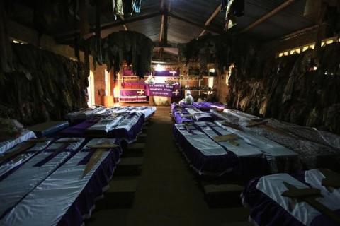 Coffins containing the remains of victims of mass killings during the 1994 genocide are displayed in a Catholic Church in Nyamata, April 9, 2014. PHOTO BY REUTERS/Noor Khamis