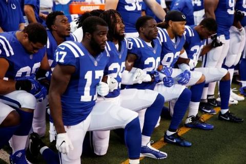 Indianapolis Colts players kneel during the playing of the National Anthem before the game against the Cleveland Browns at Lucas Oil Stadium. PHOTO BY REUTERS/Brian Spurlock/USA TODAY Sports