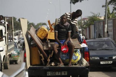 Residents move their belongings after a series of explosions destroyed homes and buildings in the Mpila neighbourhood of Congo Republic's capital Brazzaville