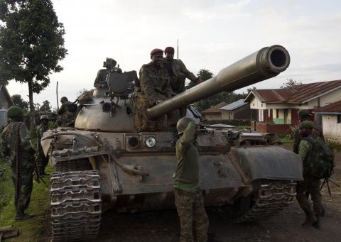 Congolese soldiers arrive atop a tank in Bunagana, north of Goma