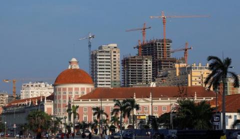 Office blocks under construction stand behind the Angolan central bank building in the capital Luanda. PHOTO BY REUTERS/Mike Hutchings