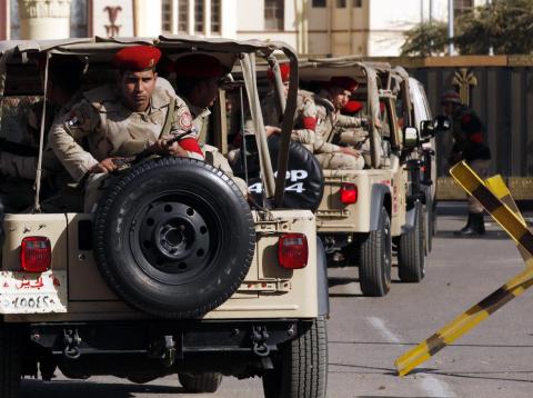 Soldiers in a convoy secure a military funeral ceremony of security personnel killed in attacks in Sinai, outside Almaza military airbase where the funerals were held, in Cairo, January 30, 2015. PHOTO BY REUTERS/Asmaa Waguih