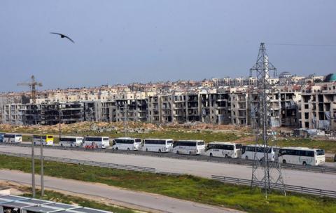 A convoy of buses carrying evacuees from the two Shi'ite villages of al-Foua and Kefraya arrive to government-controlled Aleppo, in this handout picture provided by SANA on April 12, 2017. PHOTO BY REUTERS/SANA