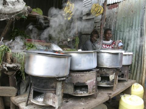 Women sit next to their cooking stoves at the sprawling Kibera slums in Kenya's capital Nairobi, June 8, 2009. Millions of people living in Kenya's slums are denied vital services and living under threat of harassment and forced eviction, posing a major threat to the country's security, Amnesty International's top official said. PHOTO BY REUTERS/Noor Khamis